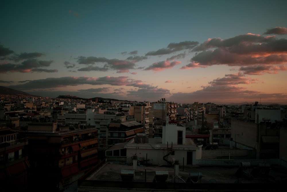 a view of a city at sunset from a rooftop