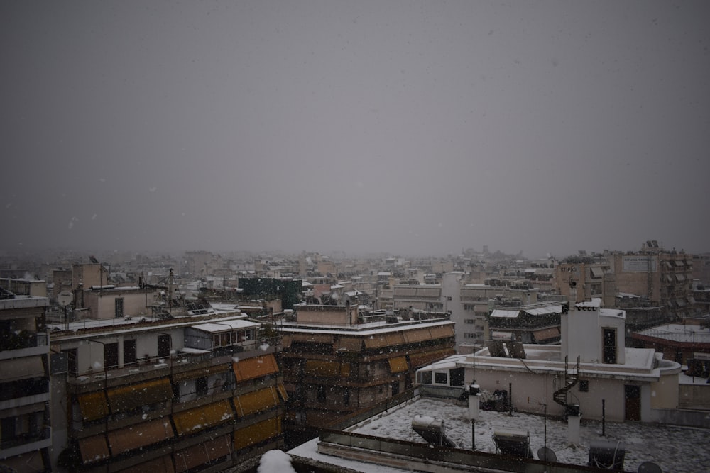 a view of a snowy city from a rooftop