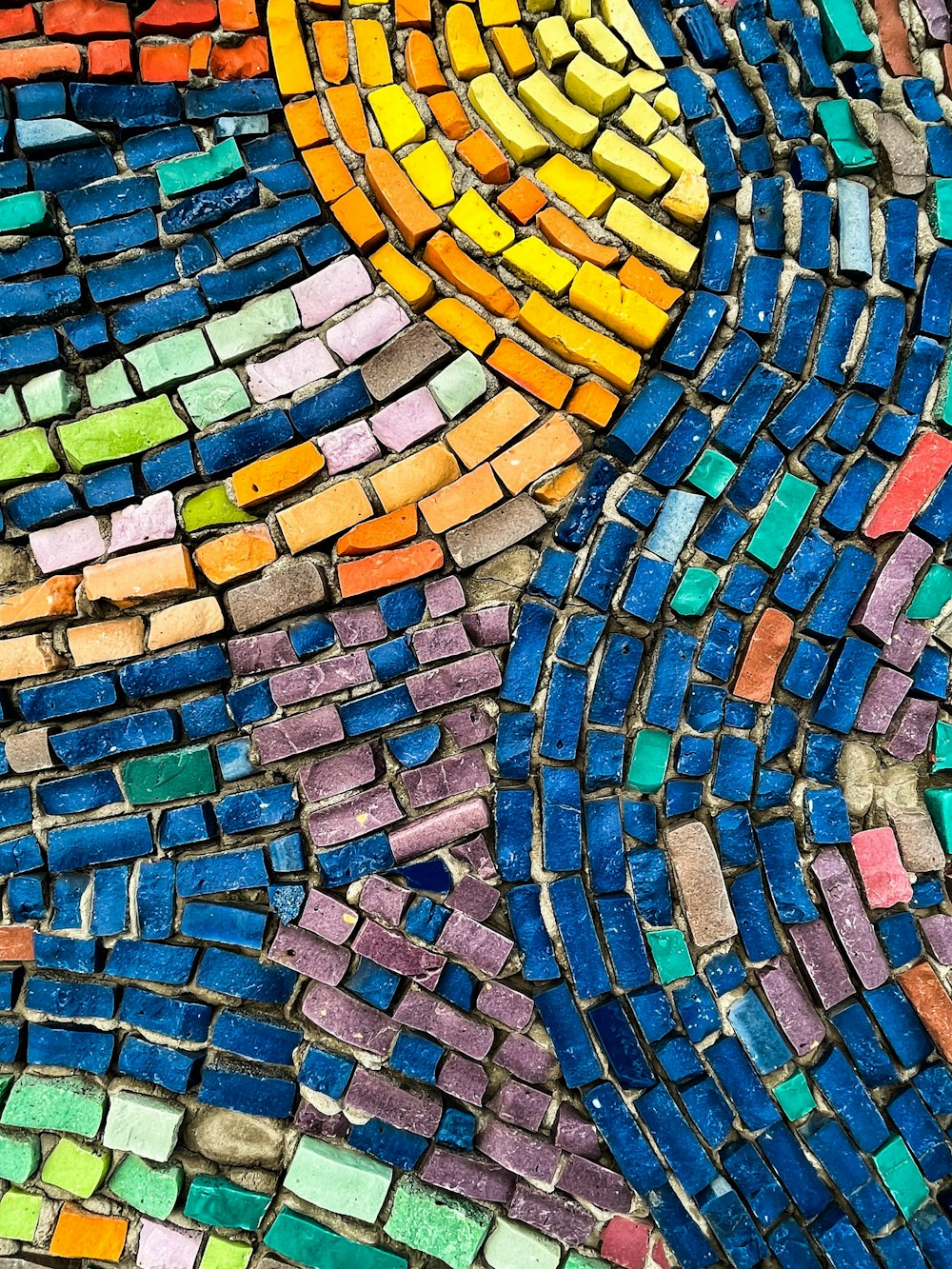 a close up of a colorful mosaic tile design