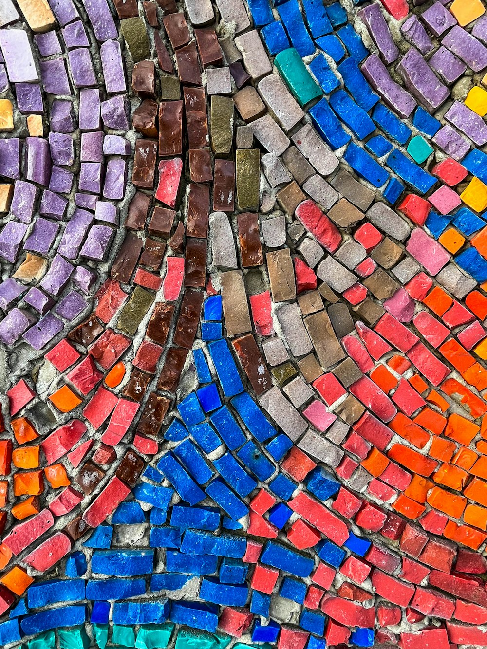 a close up of a colorful mosaic tile wall