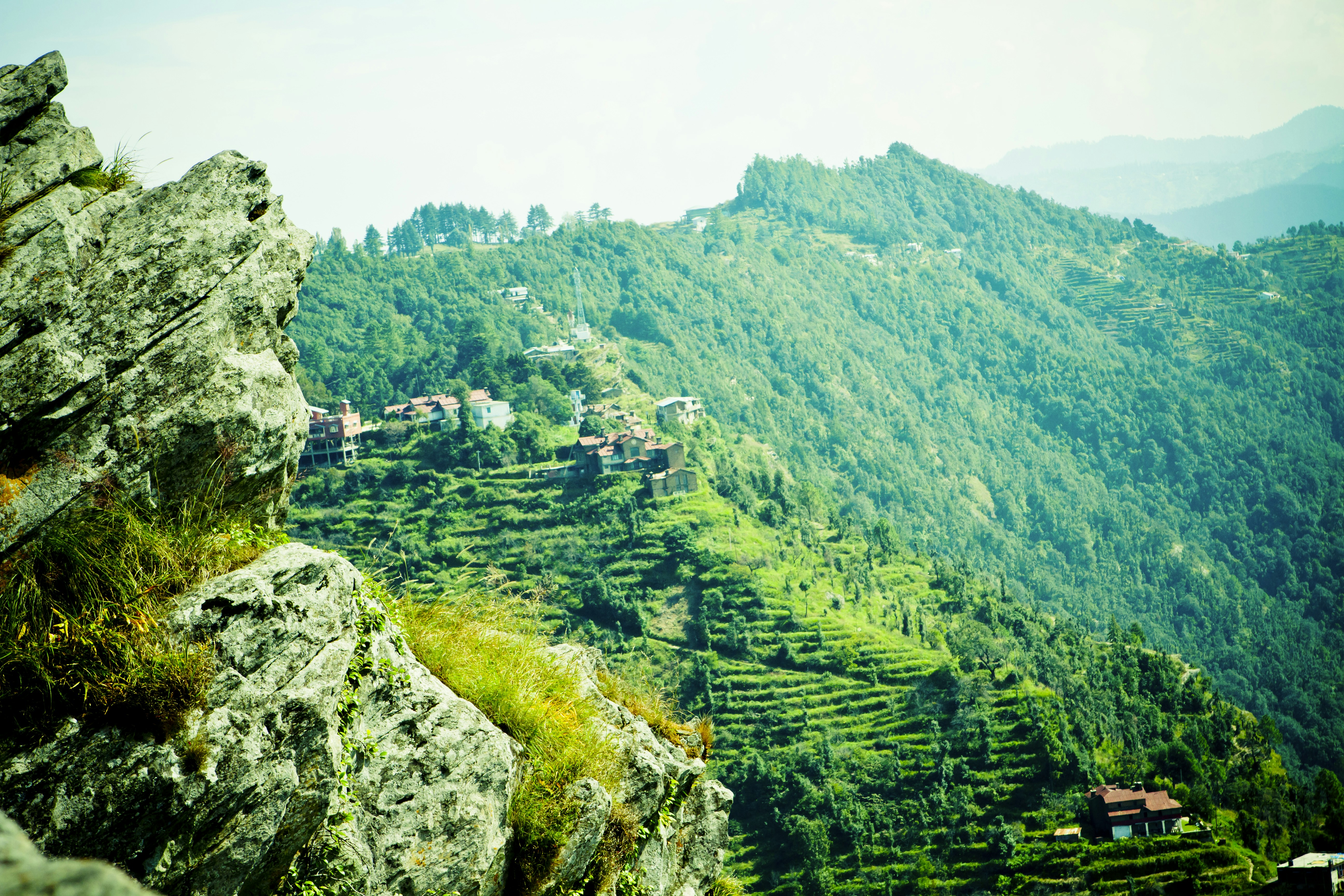 a scenic view of a green mountain range
