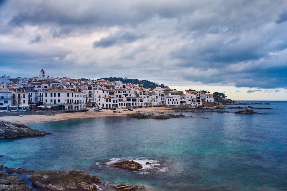 a view of a town on the shore of a body of water