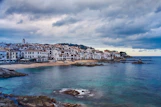 a view of a town on the shore of a body of water