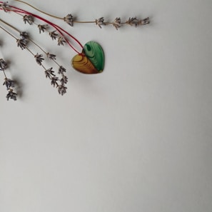 A delicate moonstone pendant resting on a bed of dried lavender.