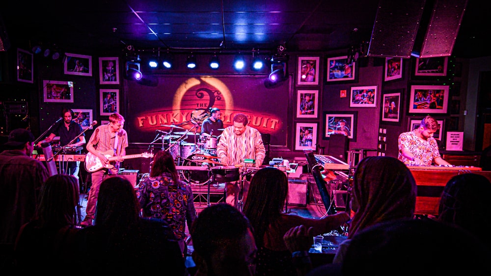 a group of people on stage playing instruments