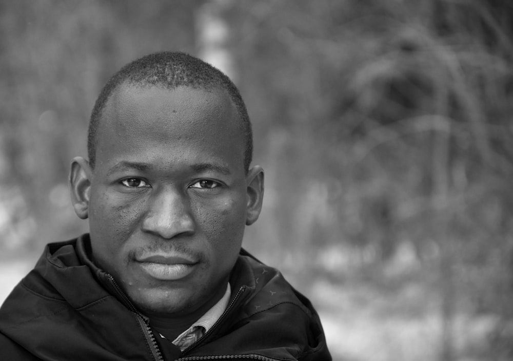 a black and white photo of a man in a jacket