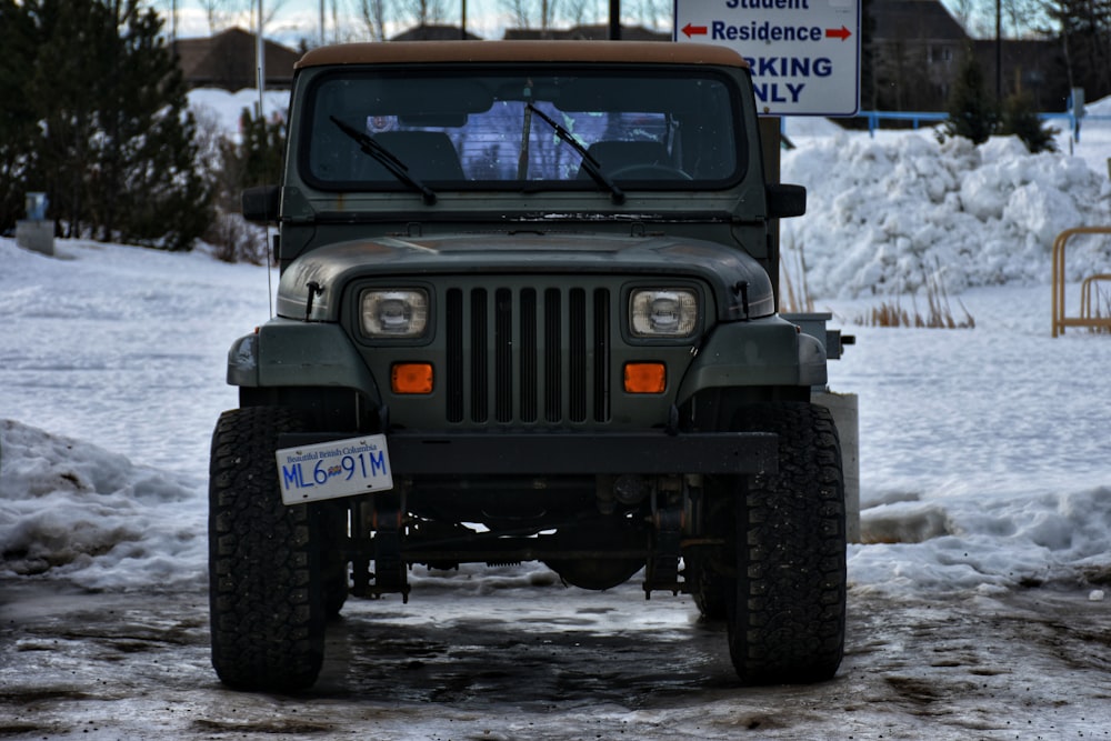 a jeep is parked on a snowy road