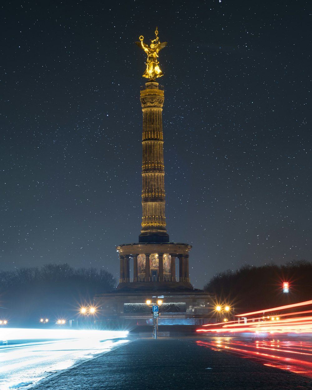 a very tall tower with a statue on top of it