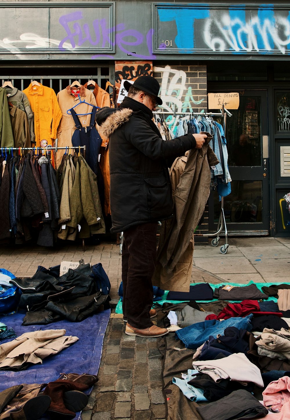 a man standing in front of a clothing store