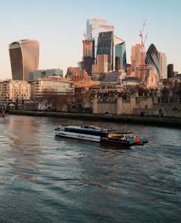 a boat on the water in front of a city
