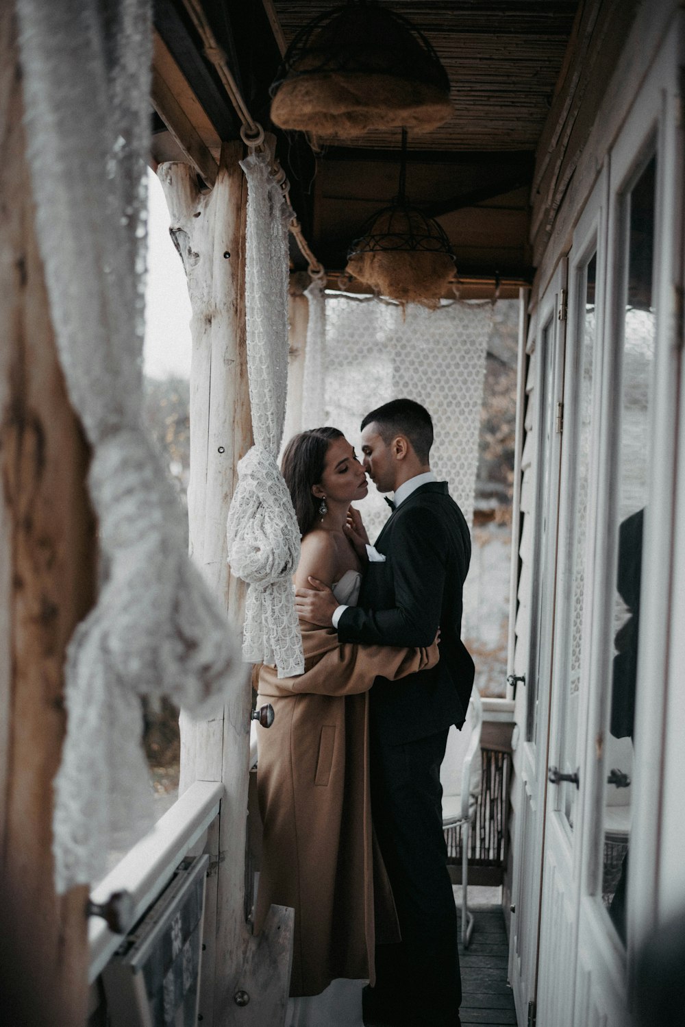 a man and a woman standing next to each other on a porch