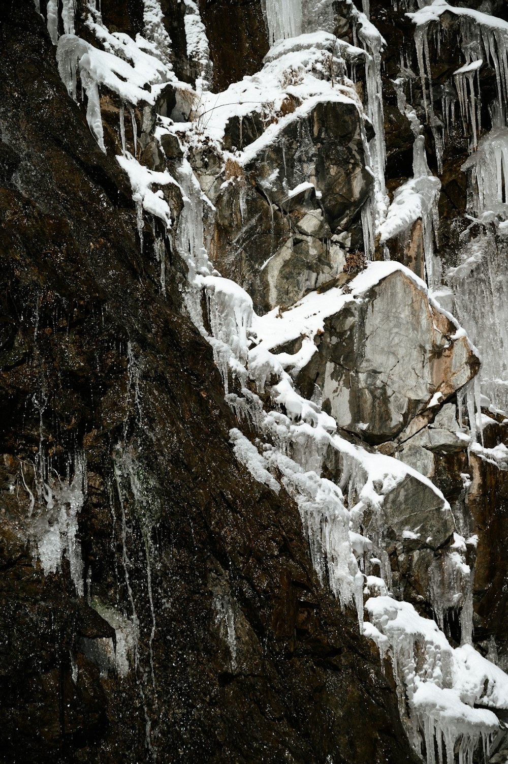 a man climbing up a mountain covered in ice