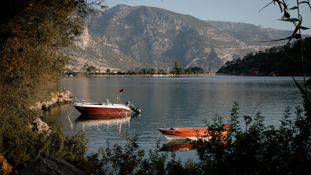 a couple of boats floating on top of a lake