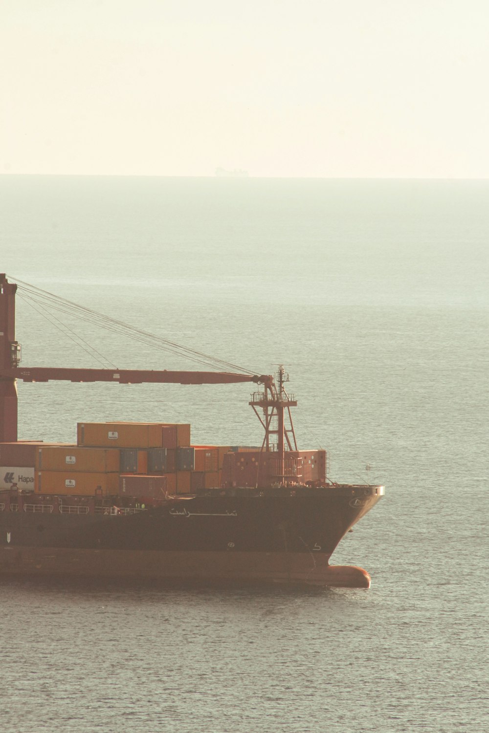 a large cargo ship in the middle of the ocean