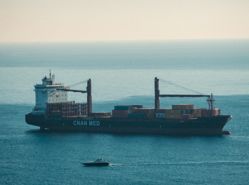 a large cargo ship in the middle of the ocean