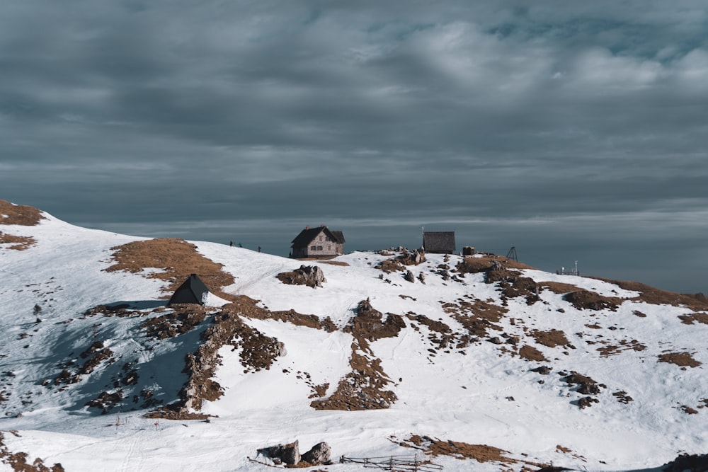 a snowy mountain with a house on top of it