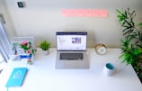 a laptop computer sitting on top of a white desk
