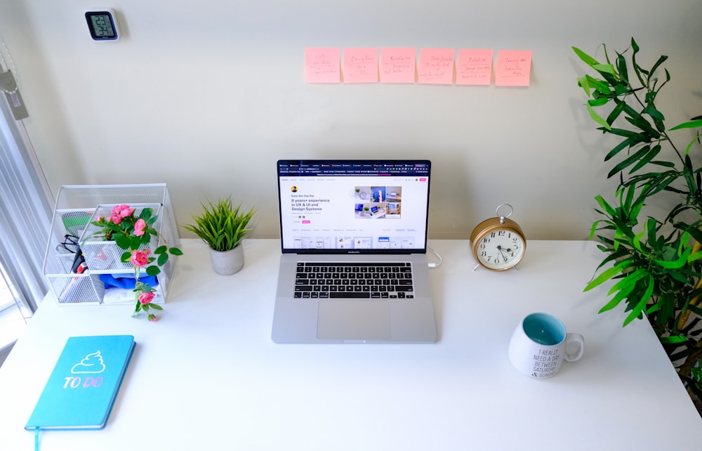 a laptop computer sitting on top of a white desk