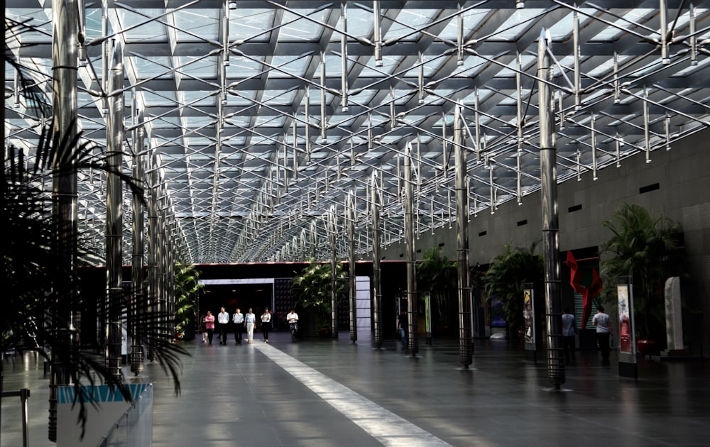 a large building with a glass ceiling and people walking around
