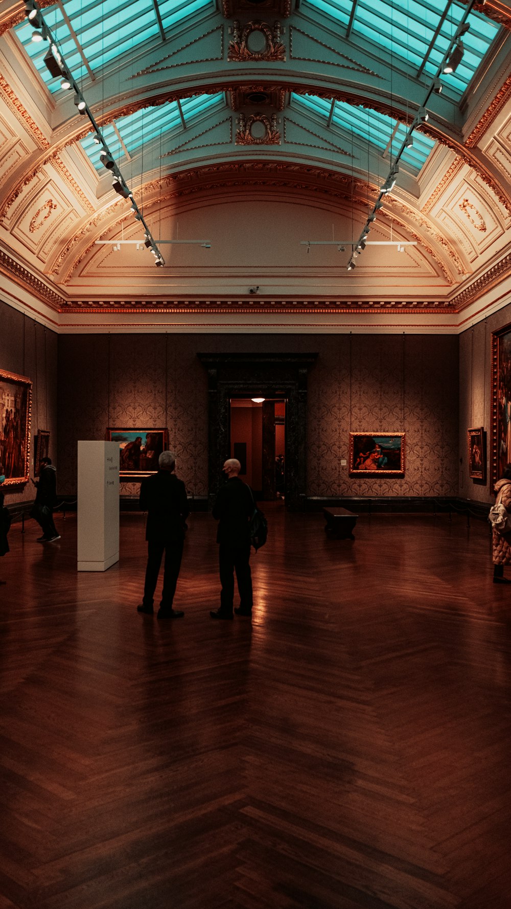 a couple of people standing in a large room