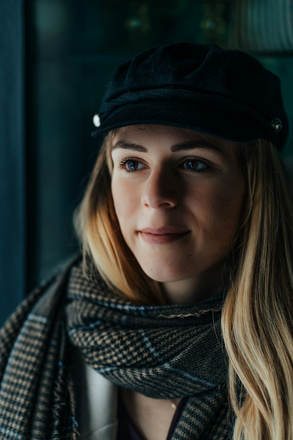 a woman wearing a black hat and scarf