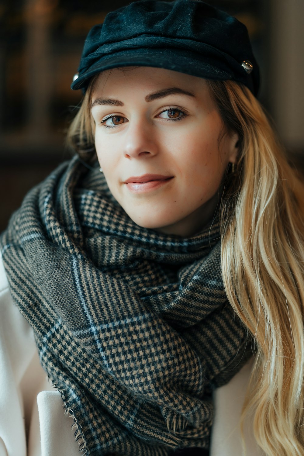 a woman wearing a hat and a scarf