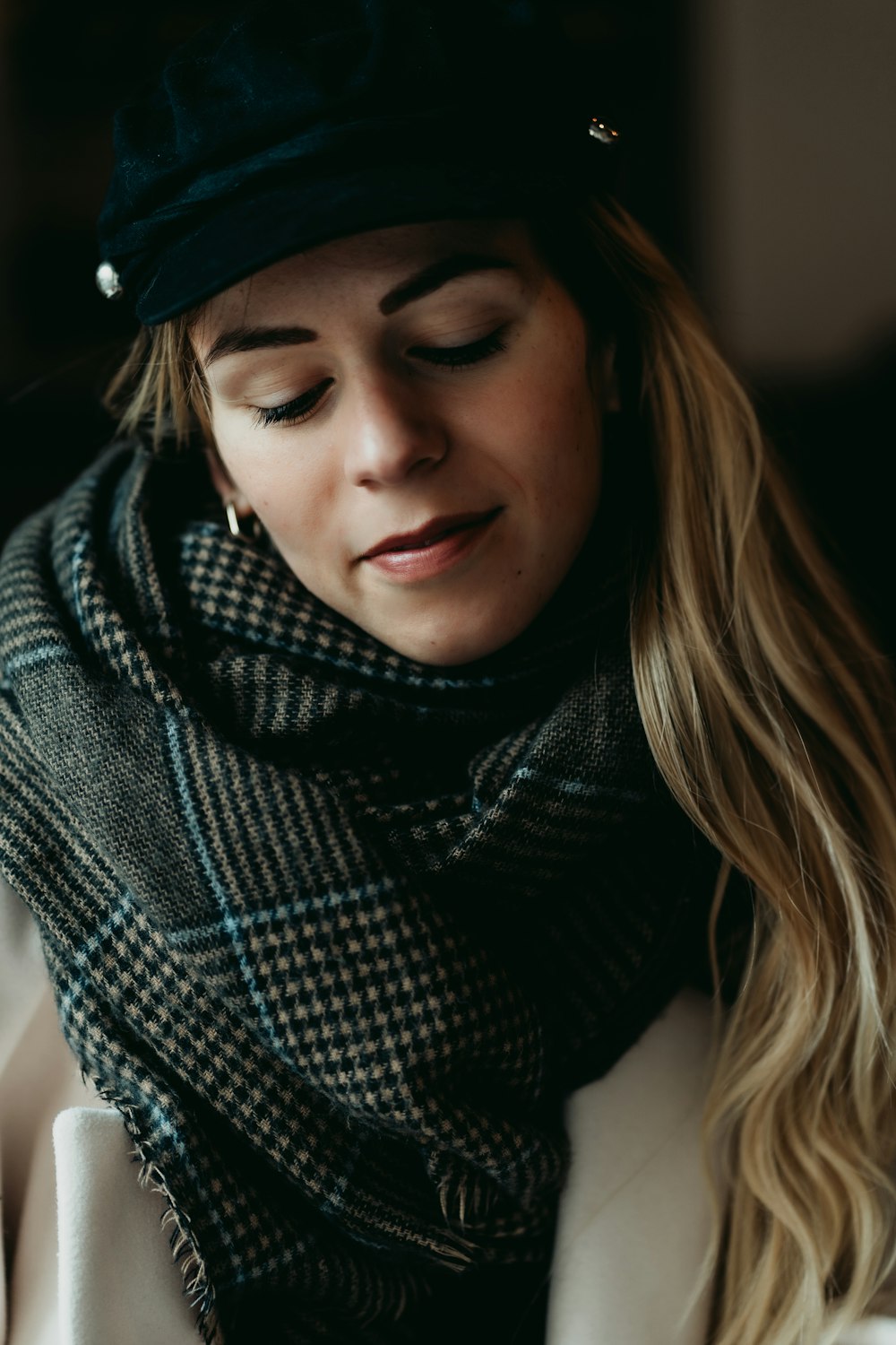 a woman wearing a black hat and scarf