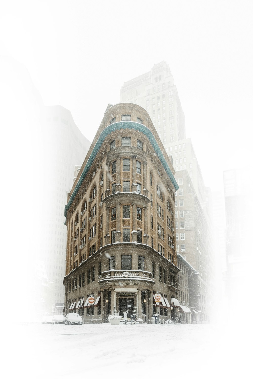 a very tall building in the middle of a snowy city