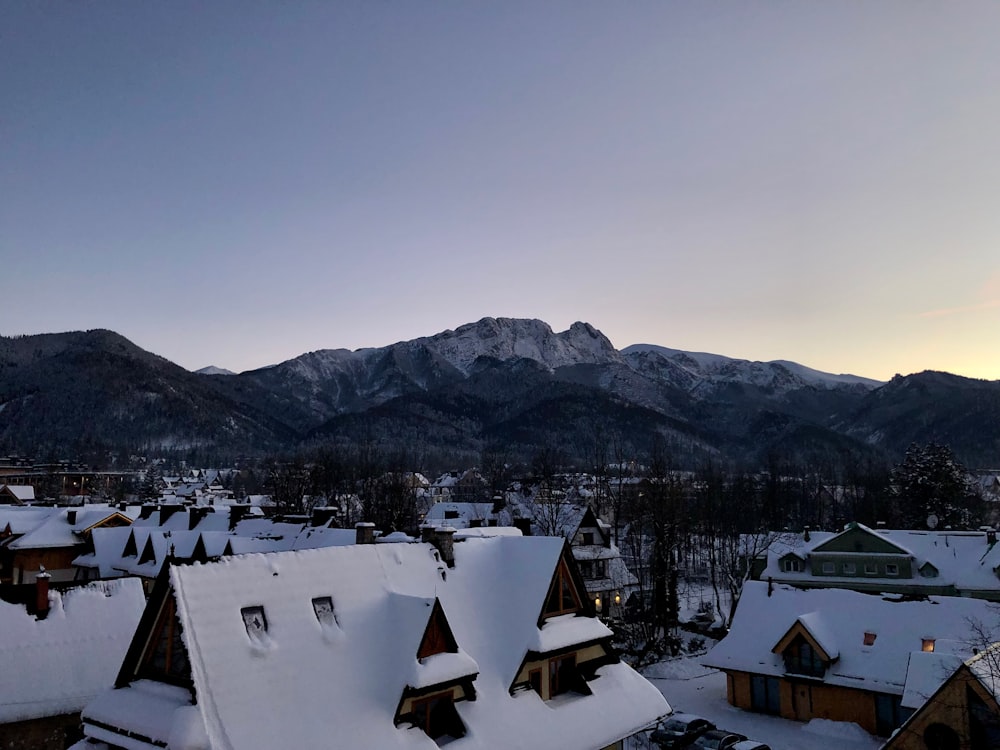 a view of a snowy mountain range from a rooftop