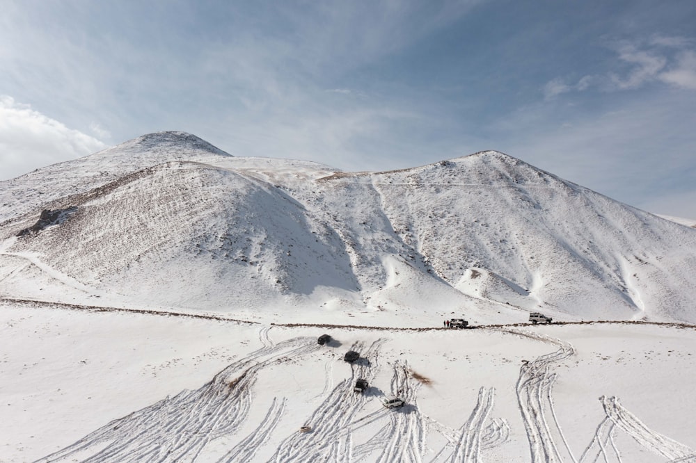 a snow covered mountain with tracks in the snow