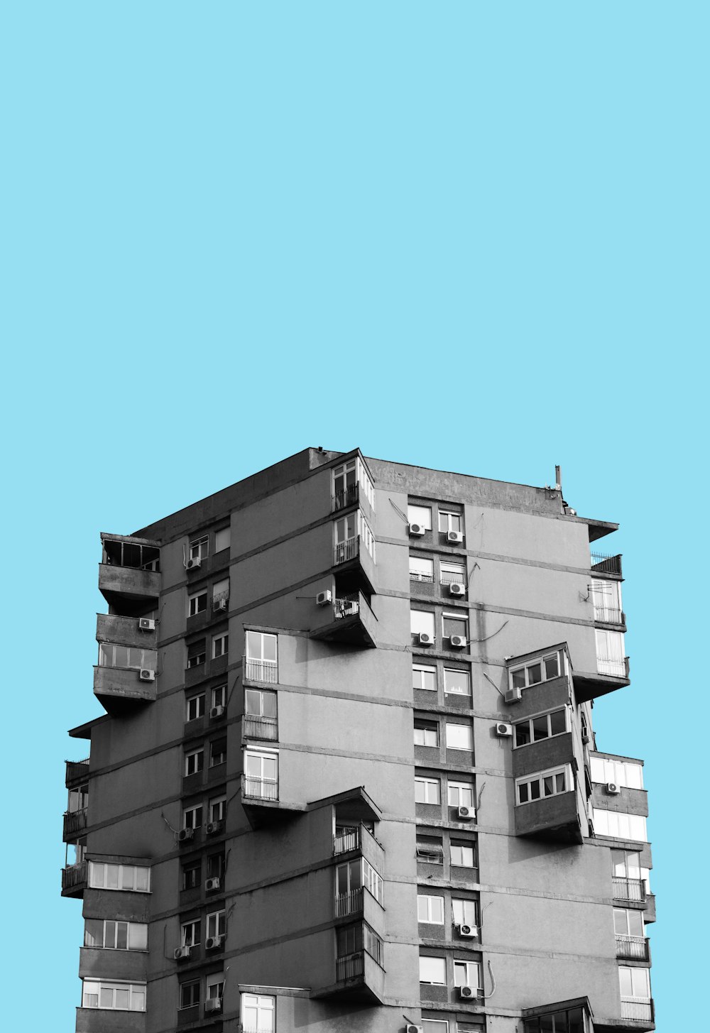 a tall building with balconies on the top of it