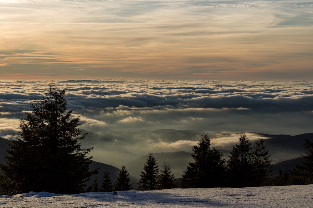 a person standing on top of a snow covered slope