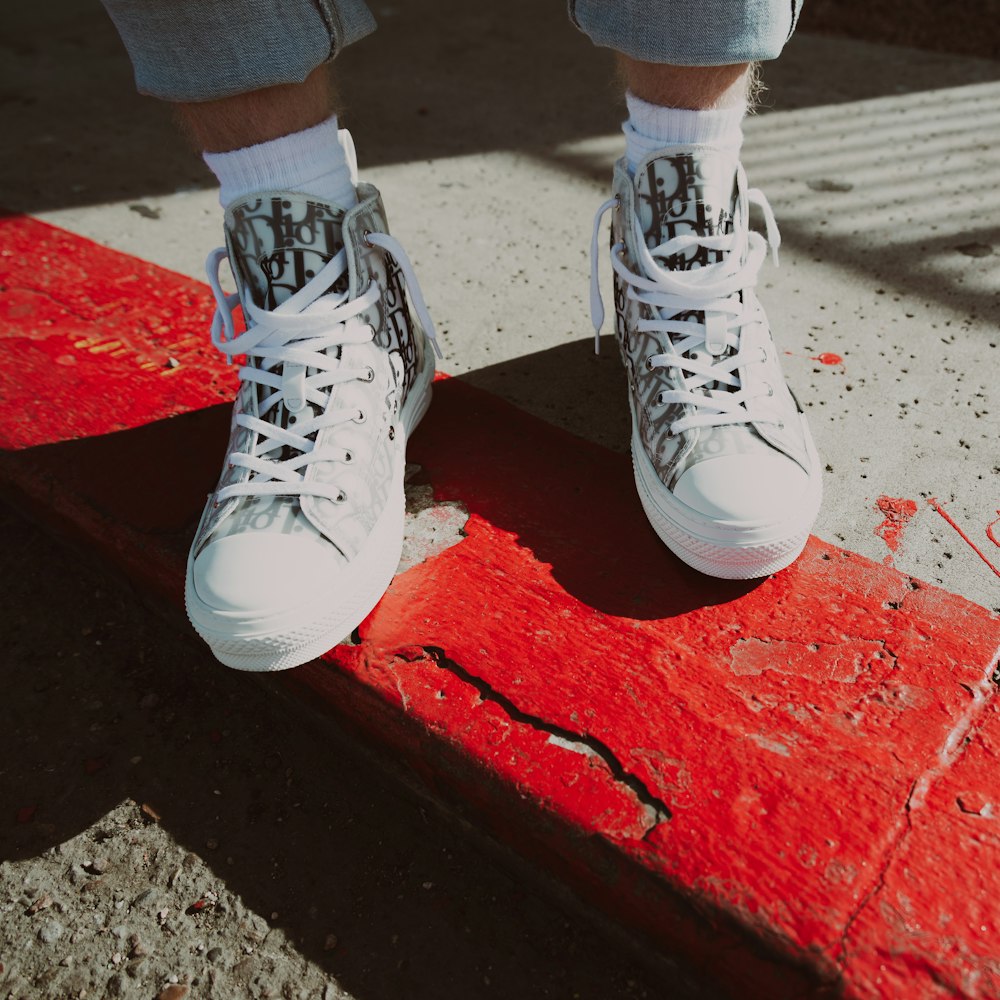 a person standing on top of a red skateboard