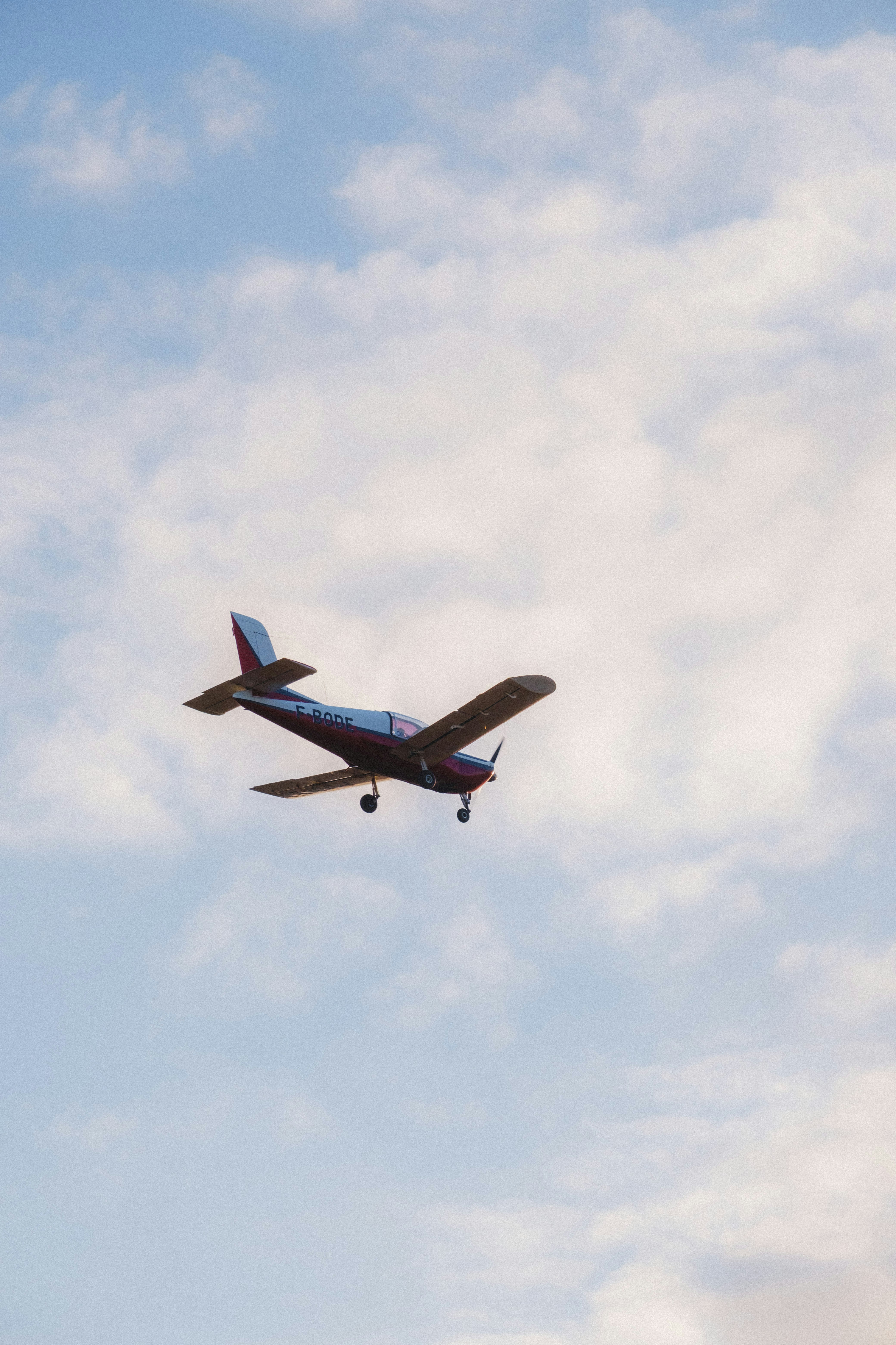 How to Find Cheap Last-Minute Flights Without Spending Hours Searching – a small airplane flying through a cloudy blue sky