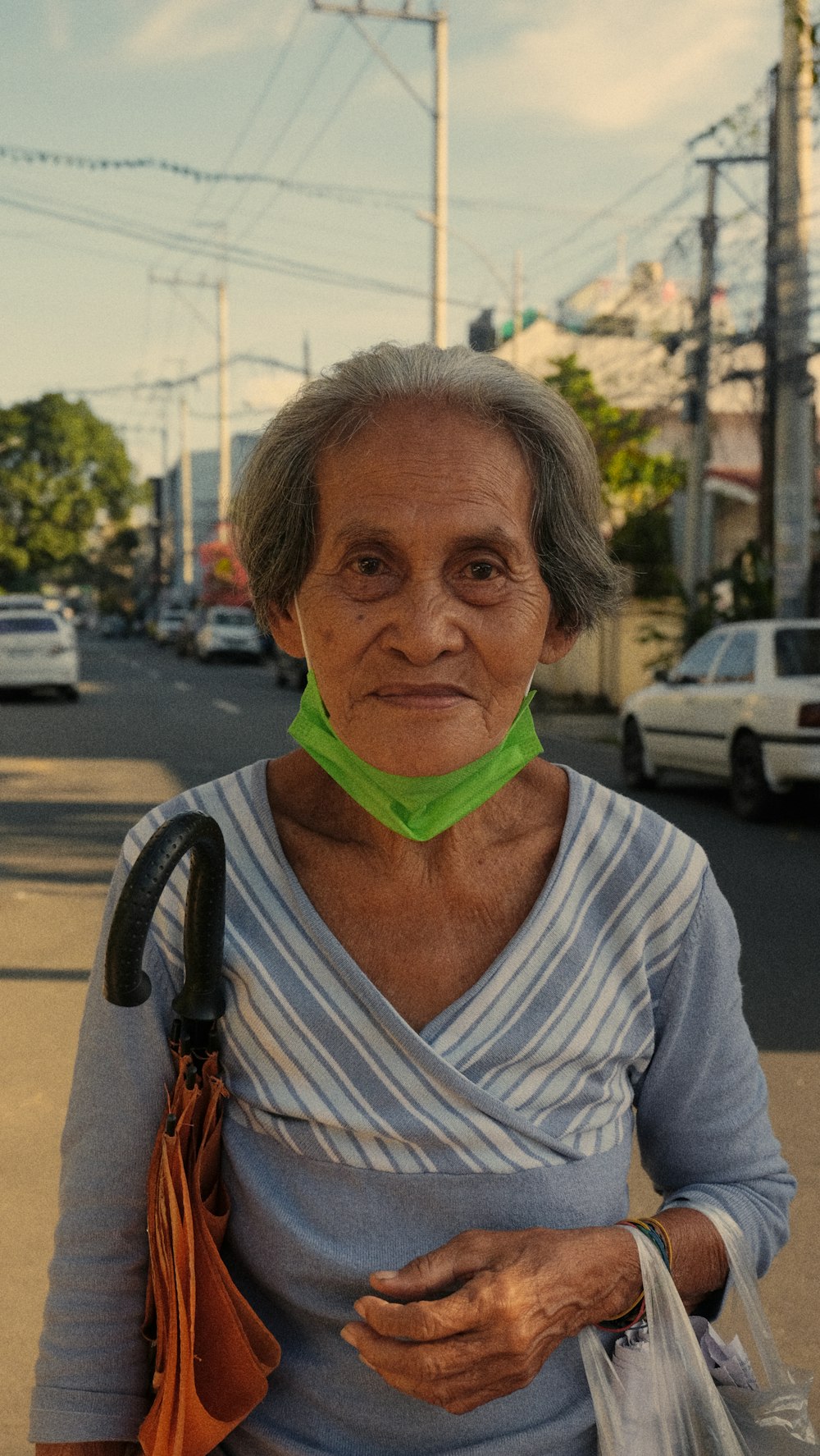 an old woman with a green collar on her neck