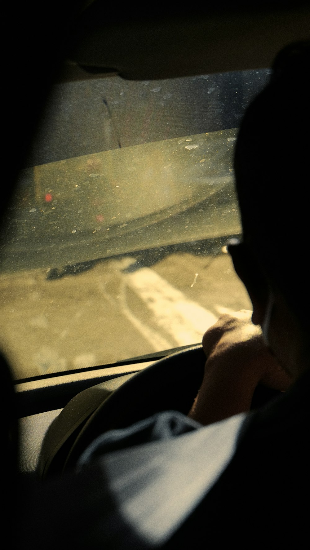 a man driving a car in the rain