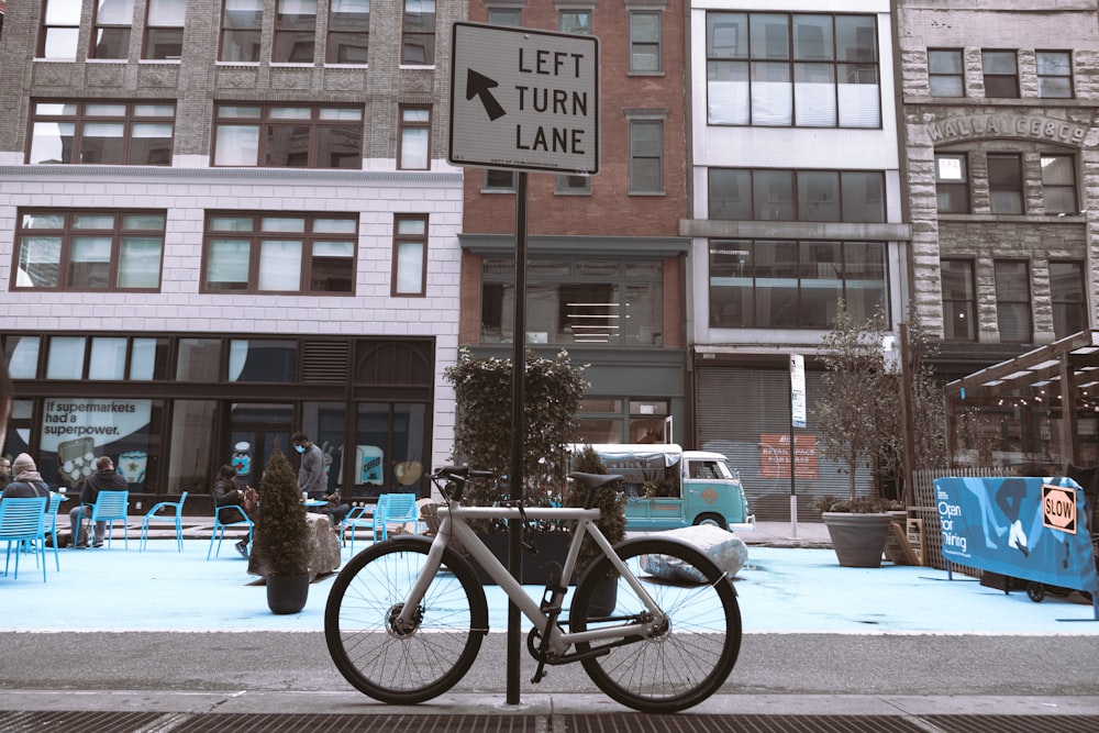 a bicycle parked on the side of a street