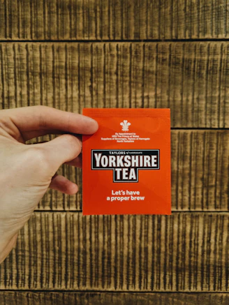 a person holding up a yorkshire tea packet