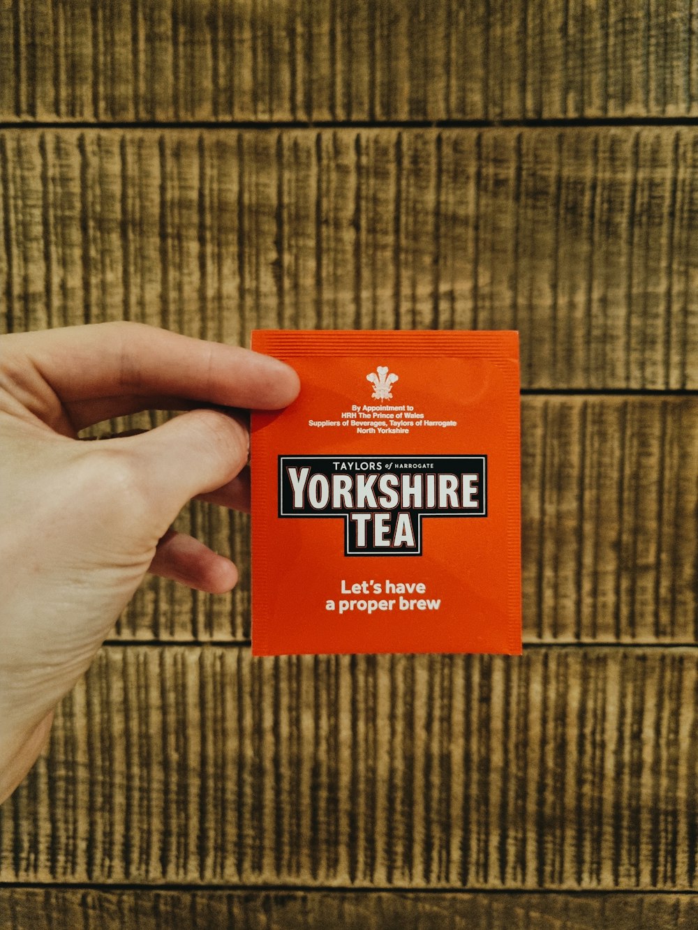 a person holding up a yorkshire tea packet