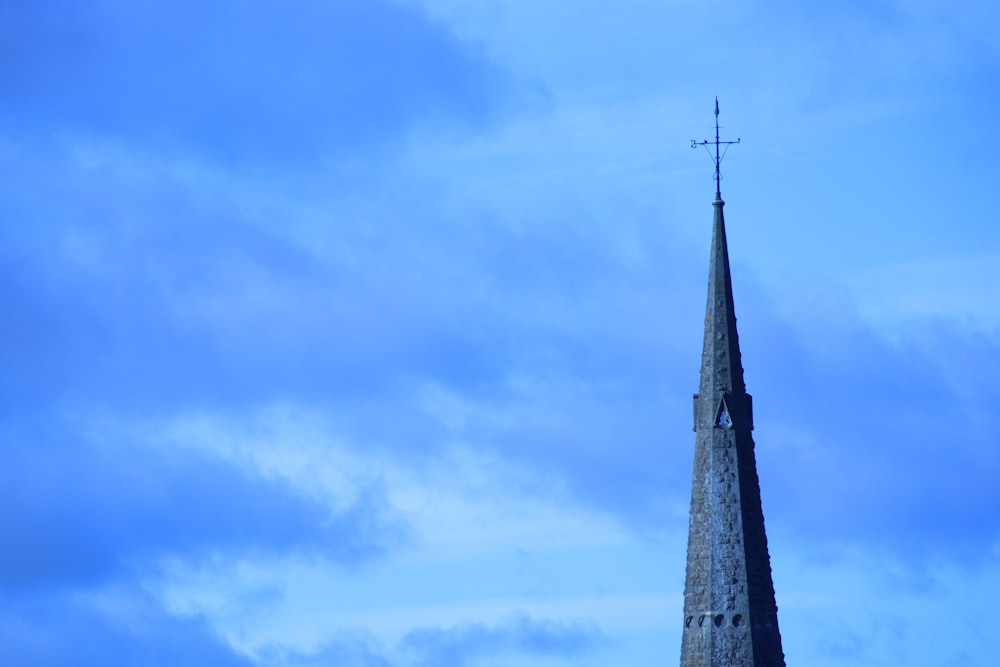 a tall steeple with a cross on top of it