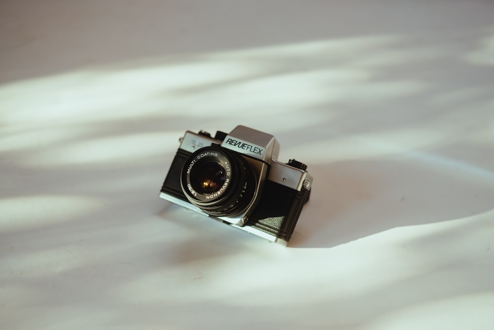 a camera sitting on top of a white surface