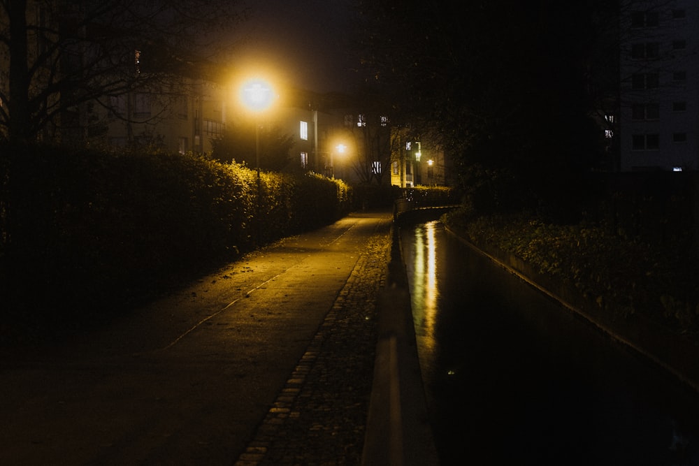 a dark street at night with a light on