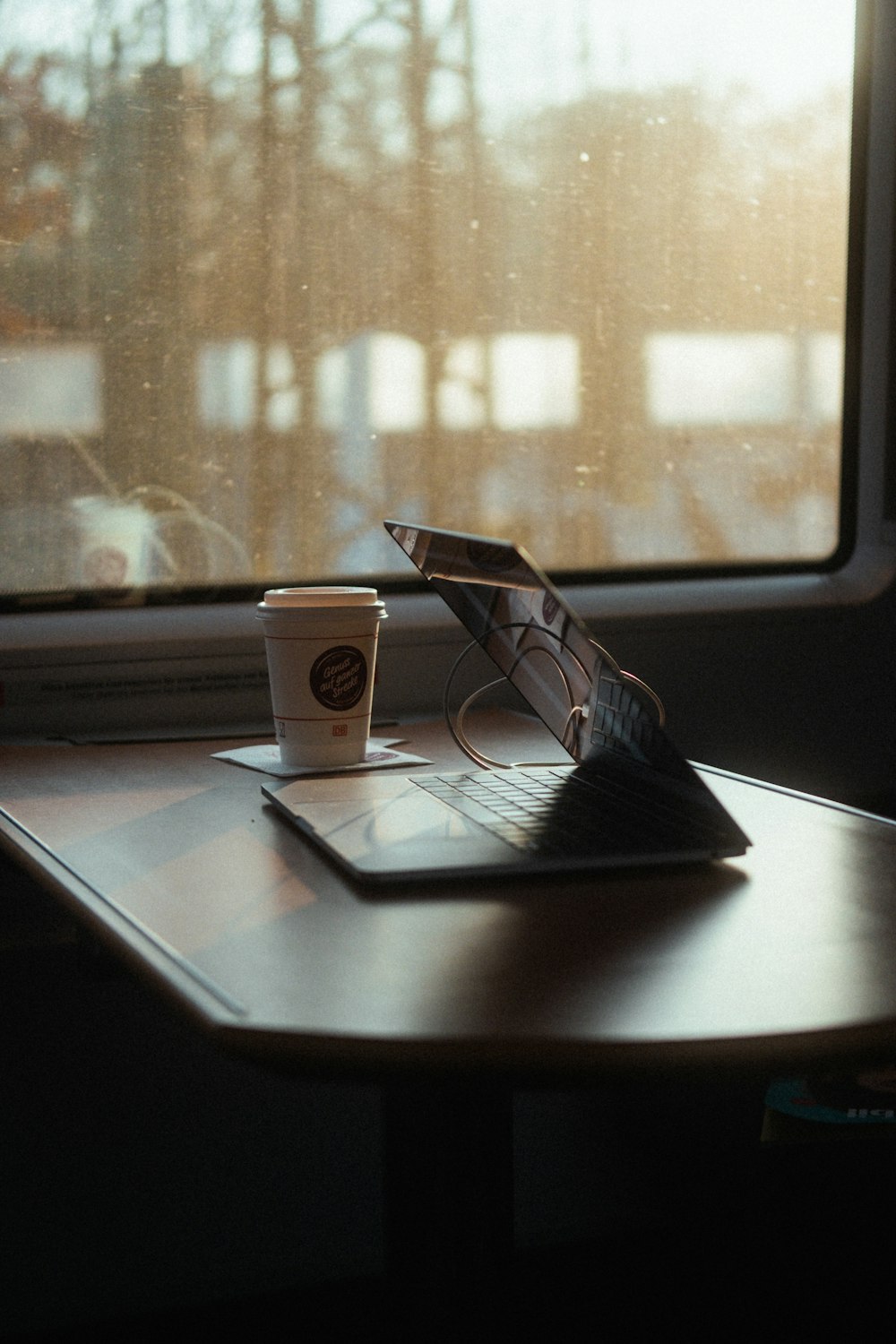 a laptop computer sitting on top of a wooden table