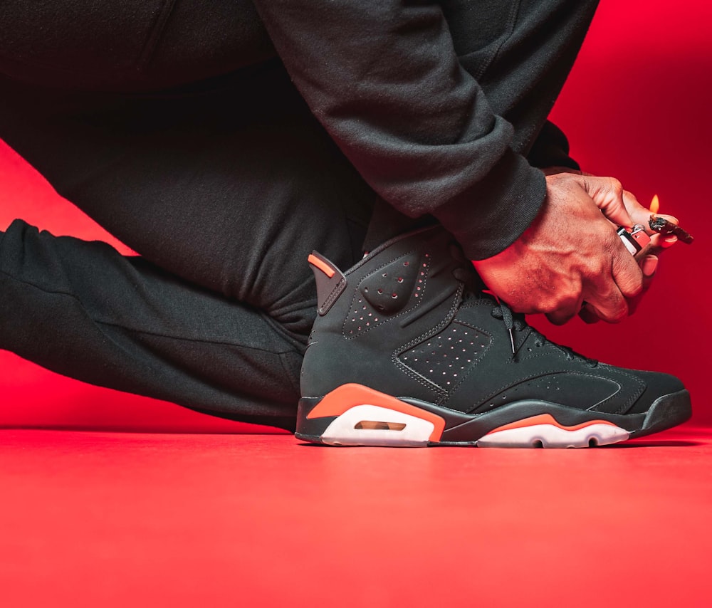 a close up of a person tying a shoelace