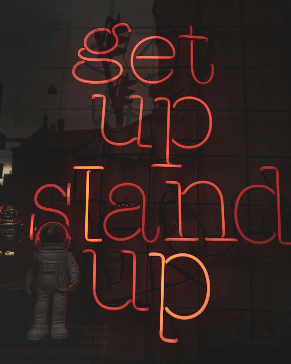 a neon sign that says get up and stand up