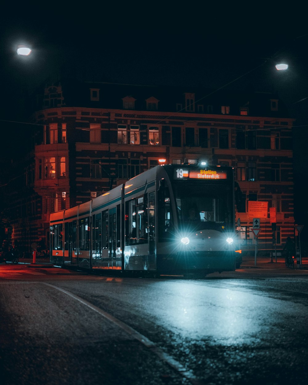 a bus driving down a street at night