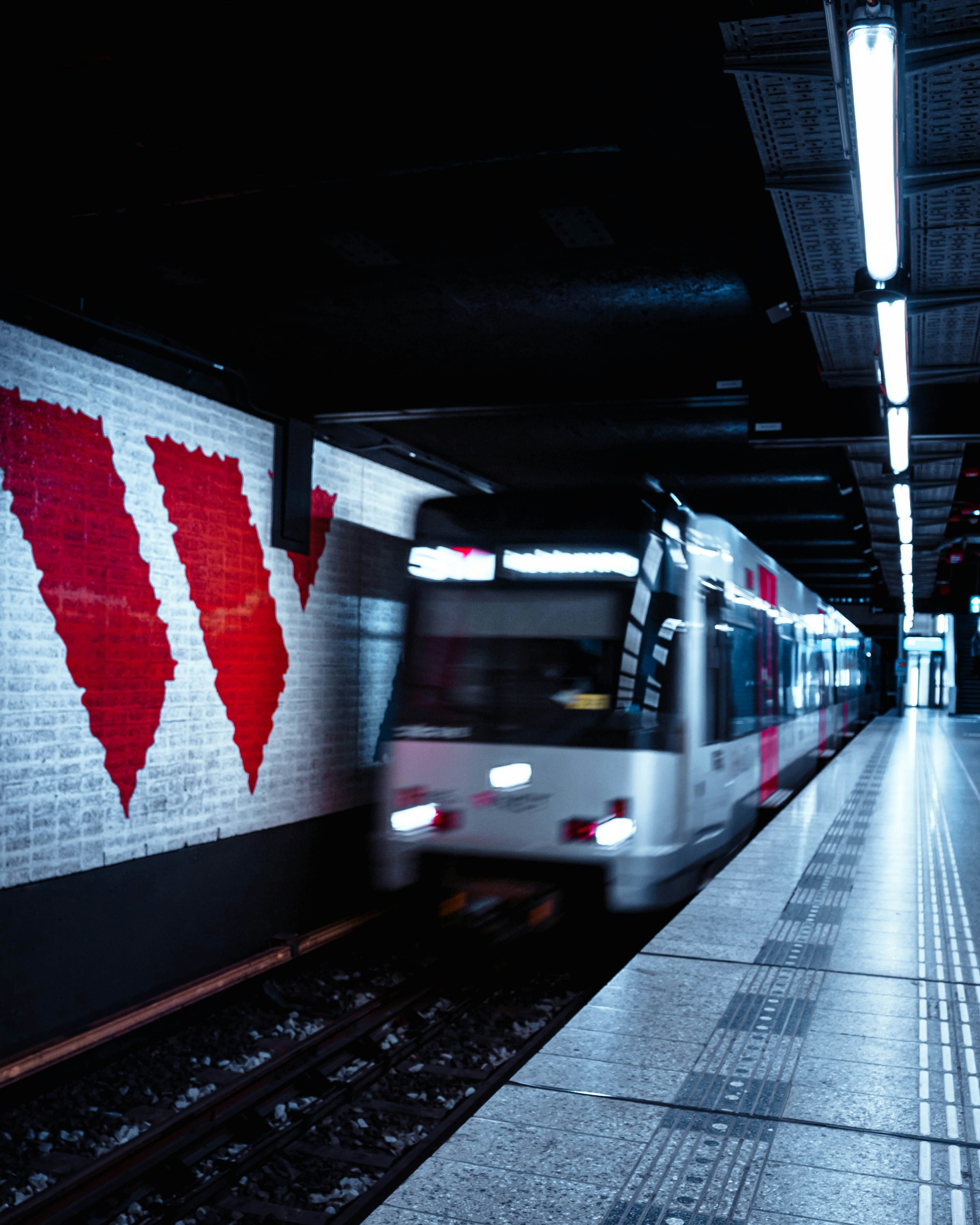 a subway train pulling into a train station