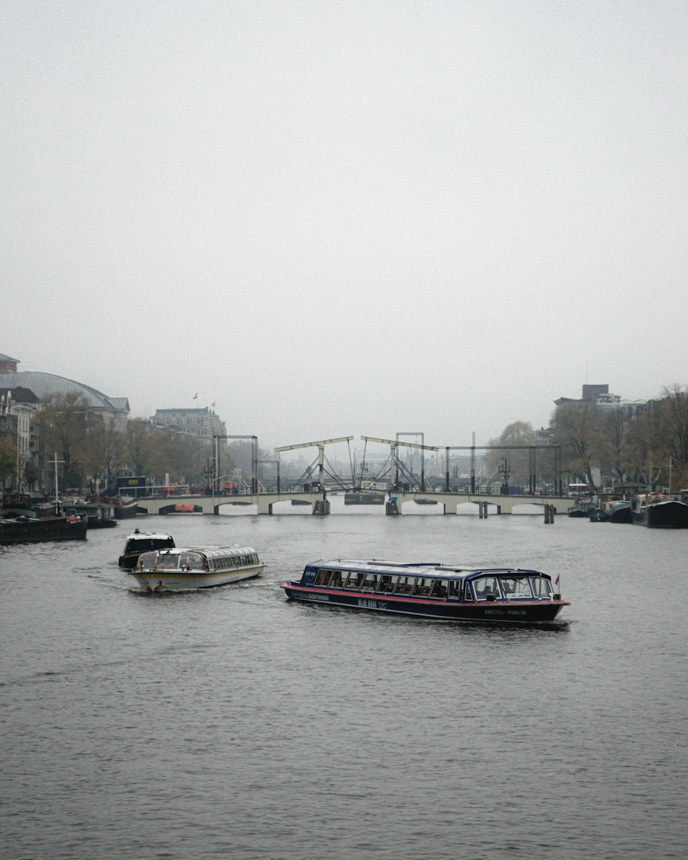 a couple of boats floating on top of a river