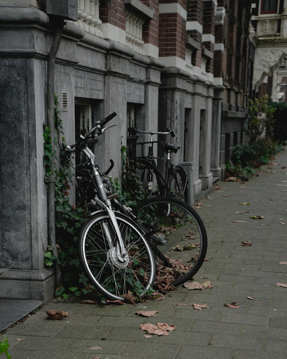 a bike parked next to a building on a sidewalk