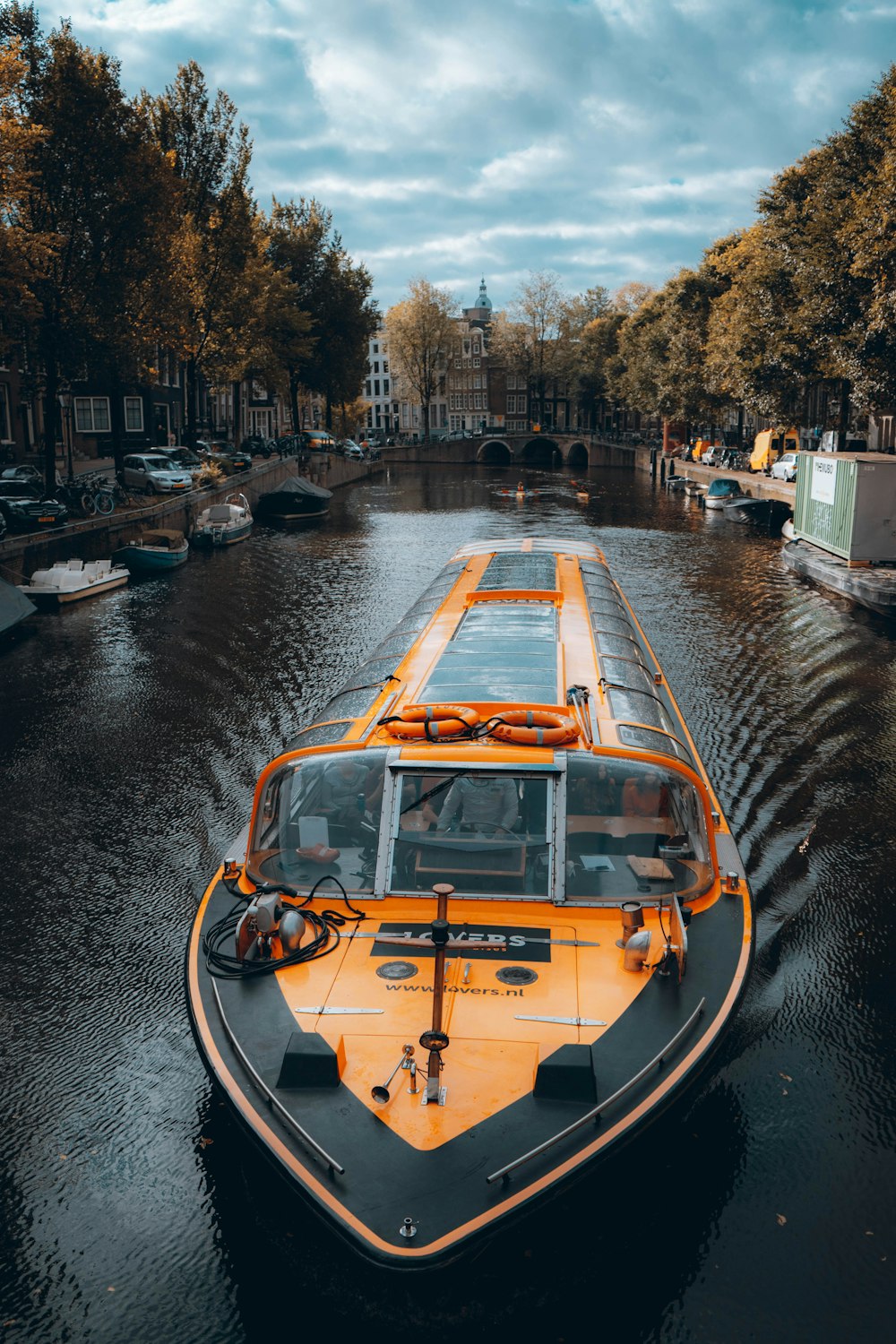 a boat is traveling down a canal in a city